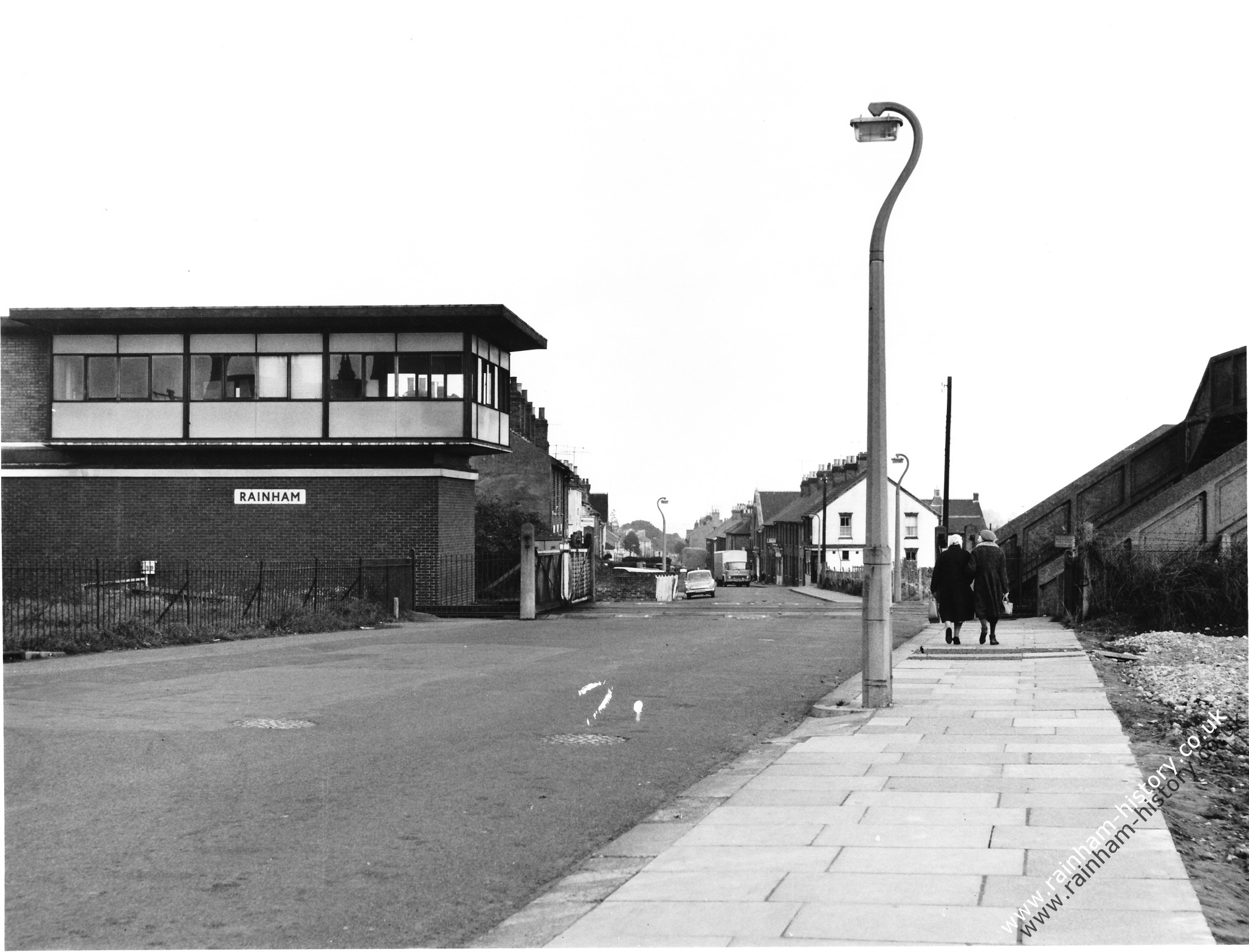 view looking down Station Road with the Rainham signal box on the left hand side of the picture. In the distance you can see a Ford Cortina and the allotments on the right hand sid